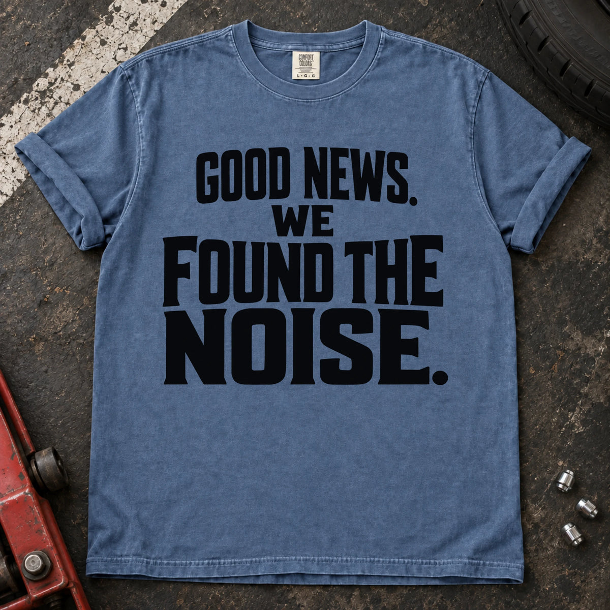 Blue Jean T-shirt with bold stacked lettering reading 'Good news. We found the noise'.