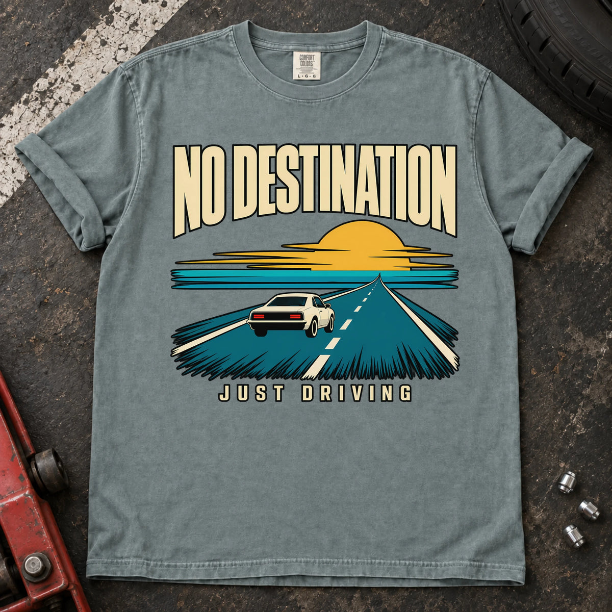 Bay T-shirt showing a car on a road toward a sunset with 'No destination, just driving'.