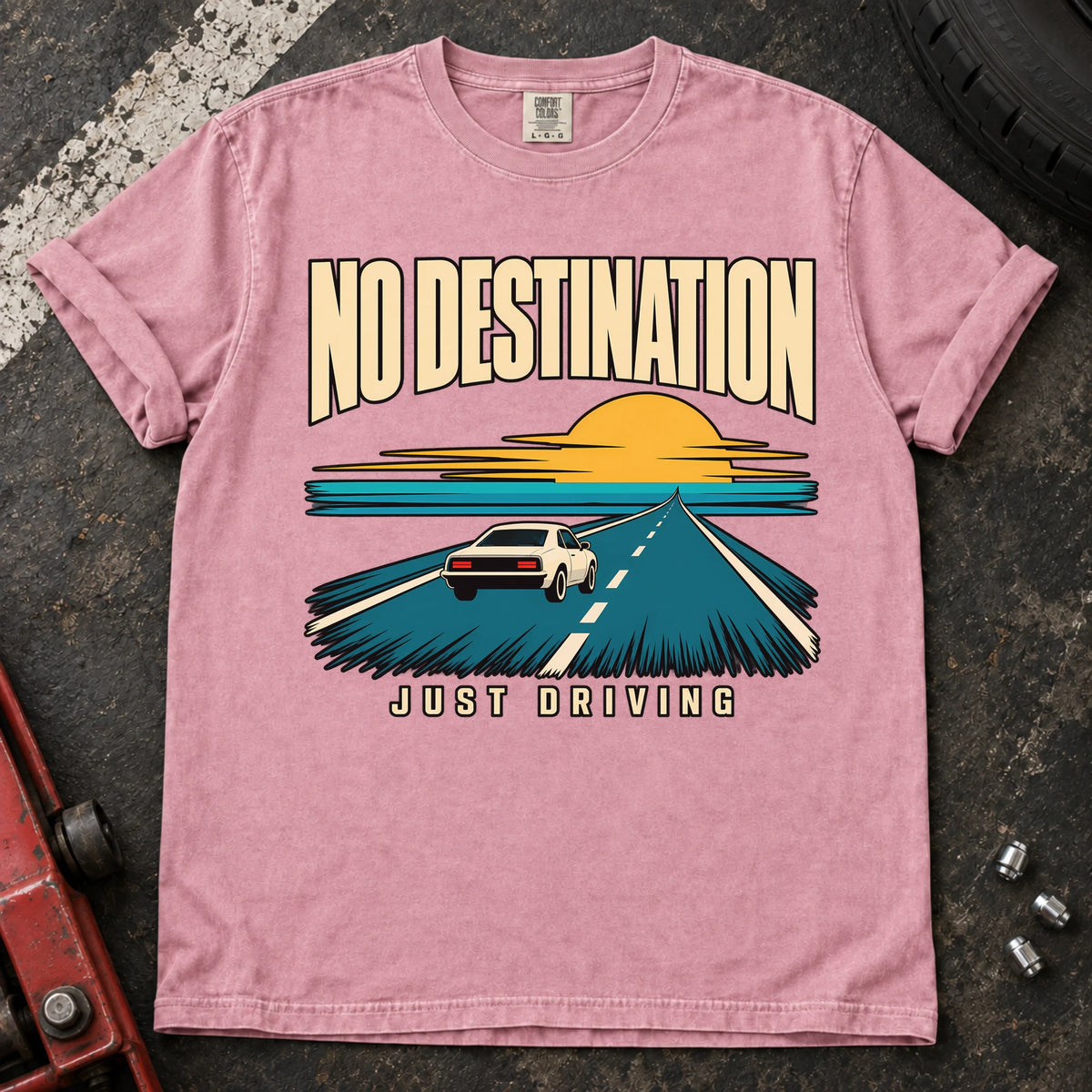 Blossom T-shirt showing a car on a road toward a sunset with 'No destination, just driving'.