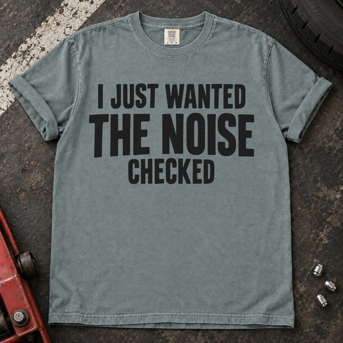 Bay T-shirt with stacked black lettering reading 'I just wanted the noise checked'.