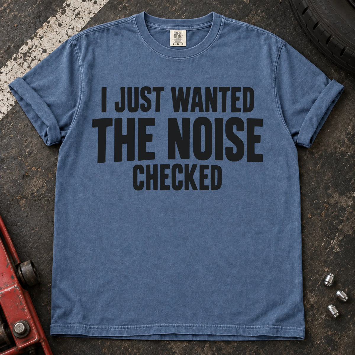Blue Jean T-shirt with stacked black lettering reading 'I just wanted the noise checked'.