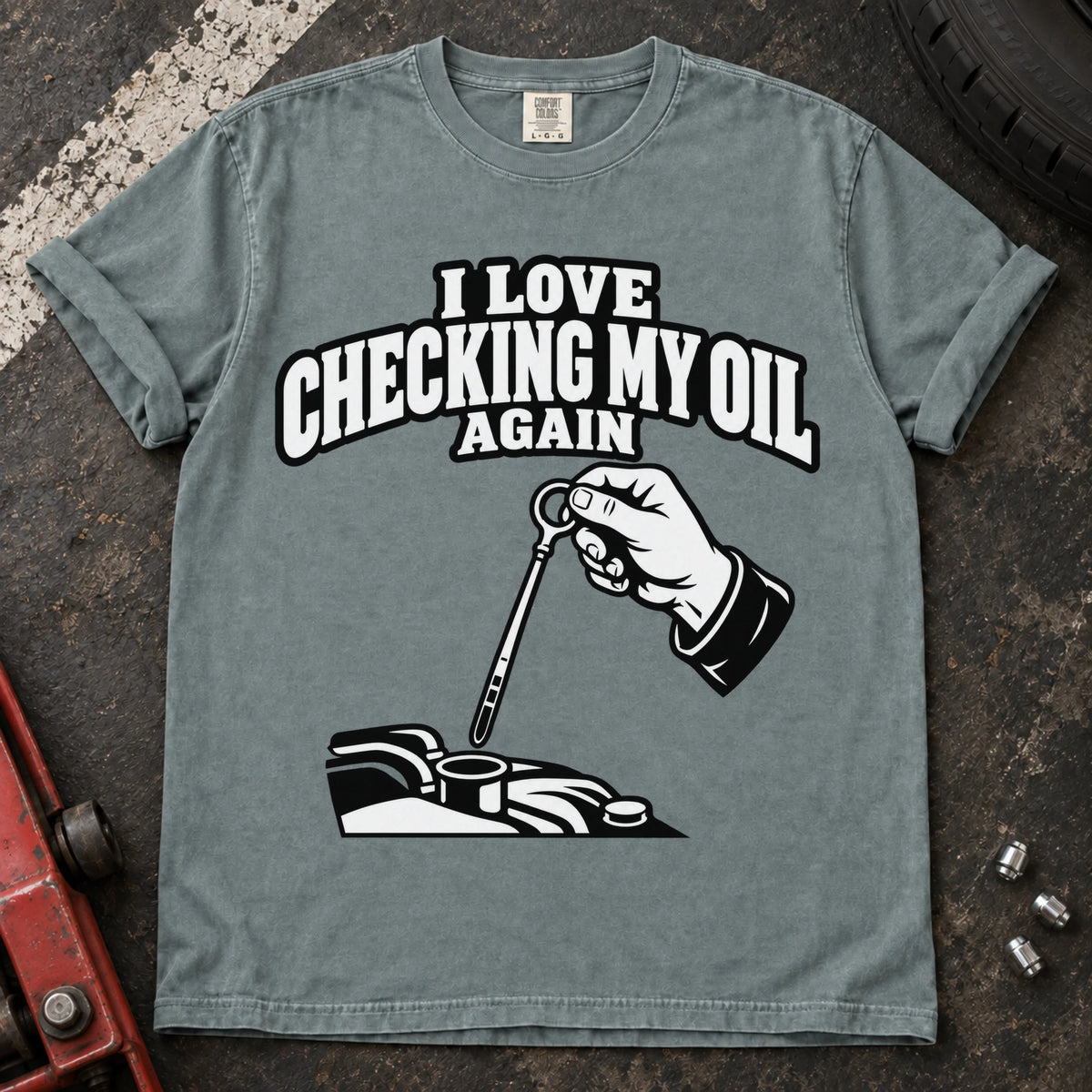 Bay T-shirt showing a hand checking an engine dipstick under 'I love checking my oil again'.