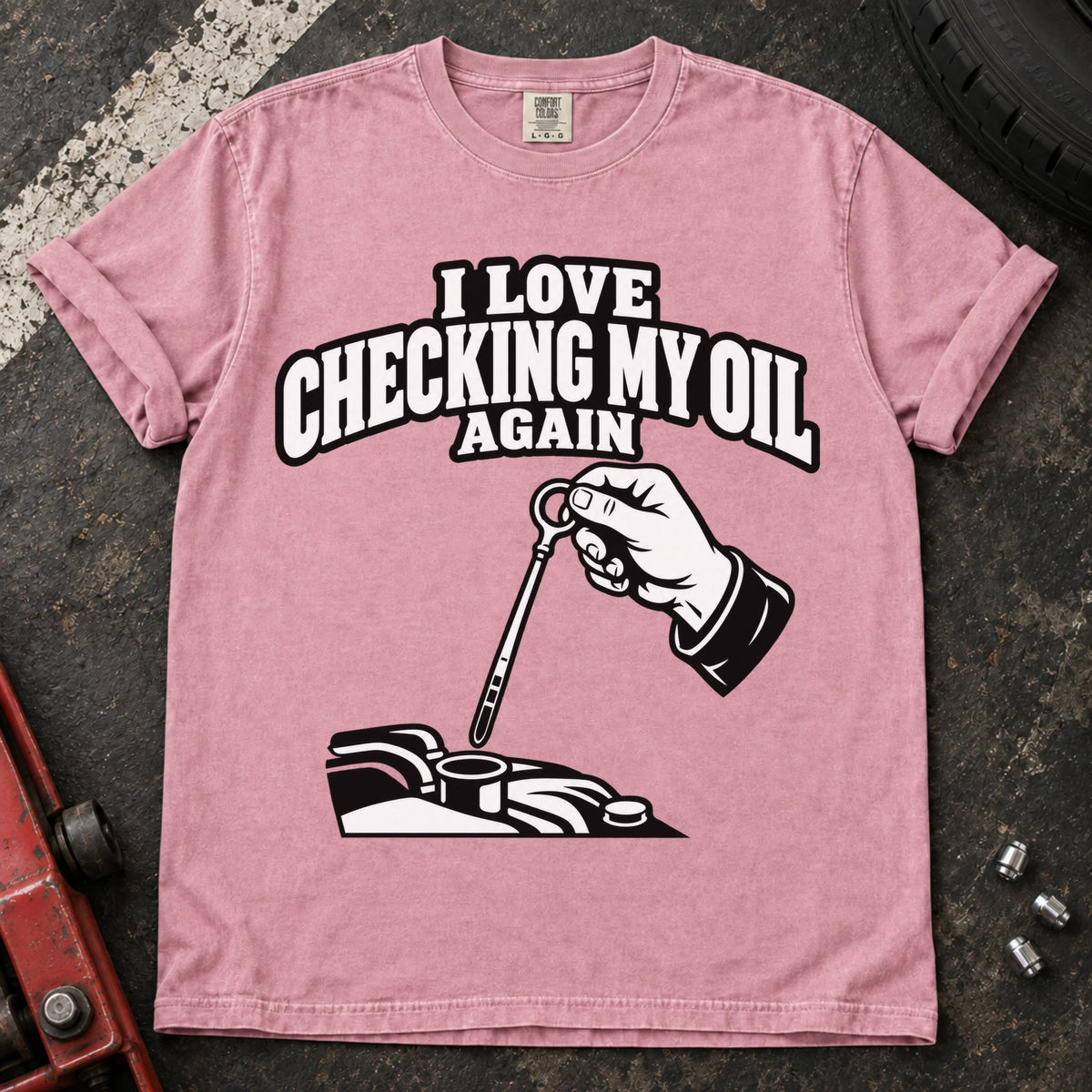 Blossom T-shirt showing a hand checking an engine dipstick under 'I love checking my oil again'.