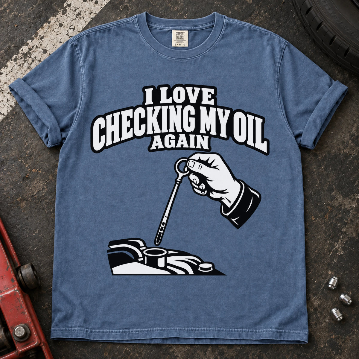 Blue Jean T-shirt showing a hand checking an engine dipstick under 'I love checking my oil again'.
