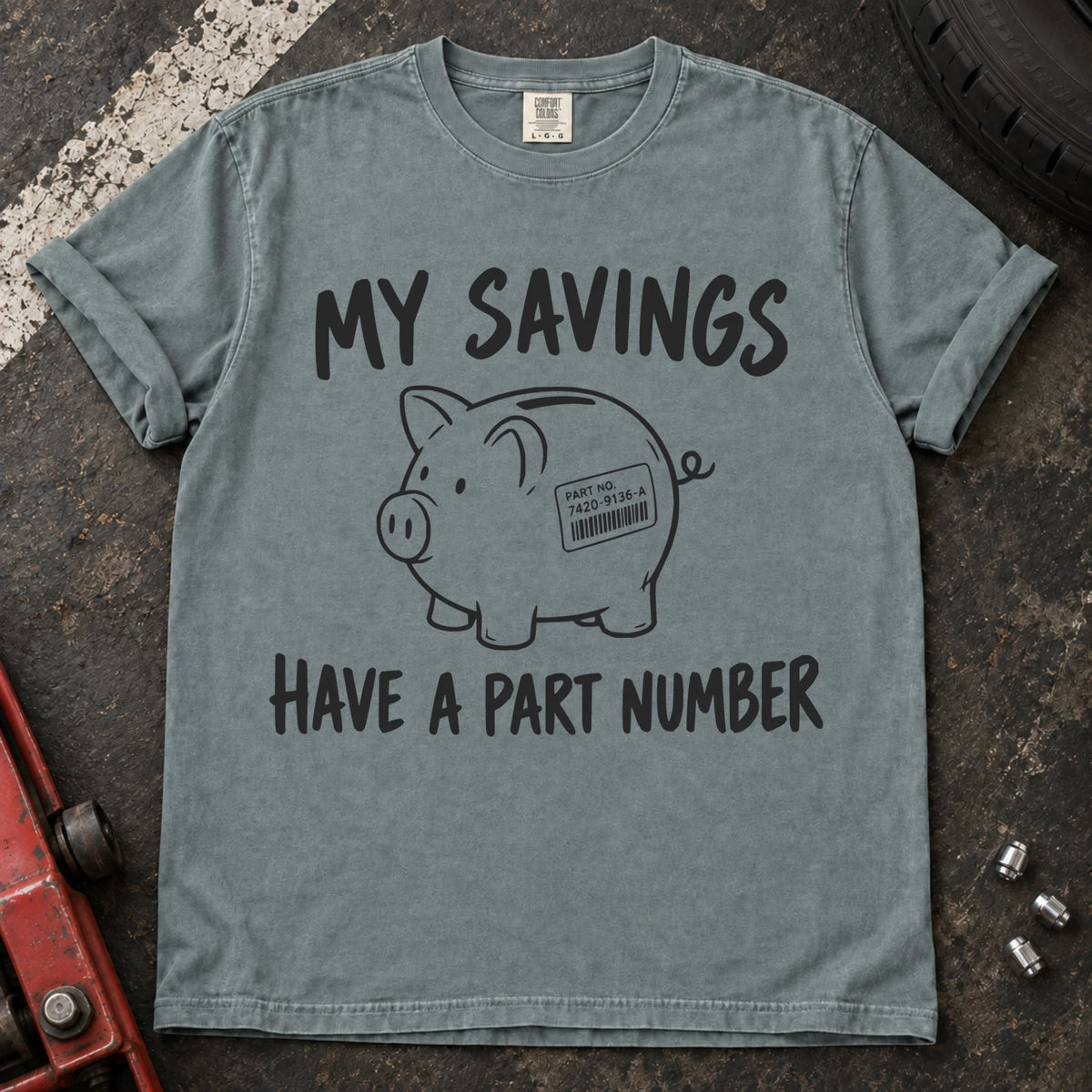 Bay T-shirt showing a piggy bank with a parts label beneath 'My savings have a part number'.