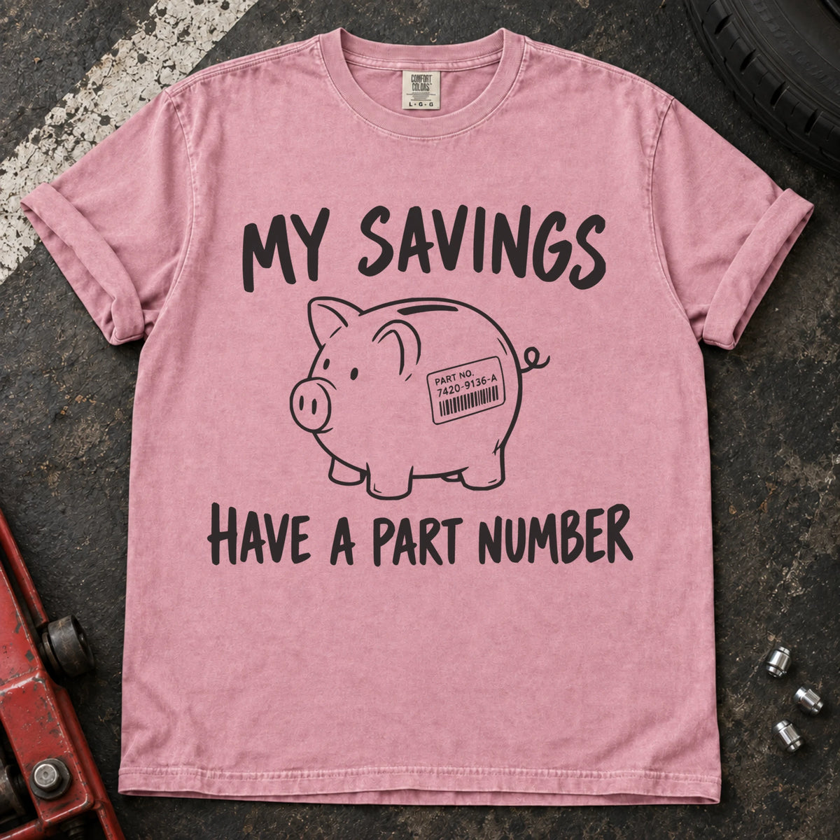 Blossom T-shirt showing a piggy bank with a parts label beneath 'My savings have a part number'.