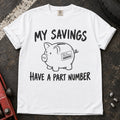 White T-shirt showing a piggy bank with a parts label beneath 'My savings have a part number'.