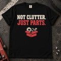 Black car enthusiast T-shirt. A box of components insists not clutter, just parts.