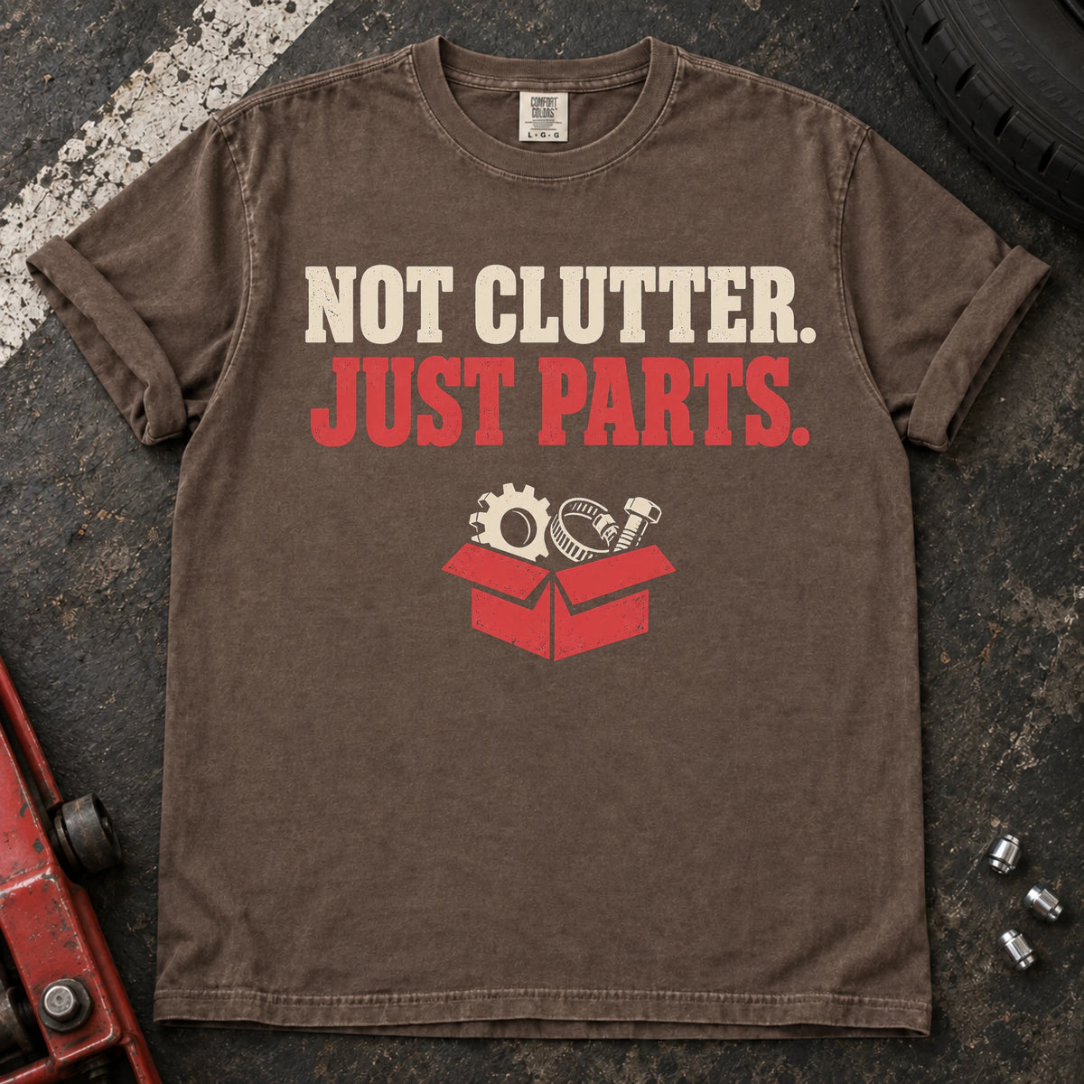 Espresso car enthusiast T-shirt. A box of components insists not clutter, just parts.