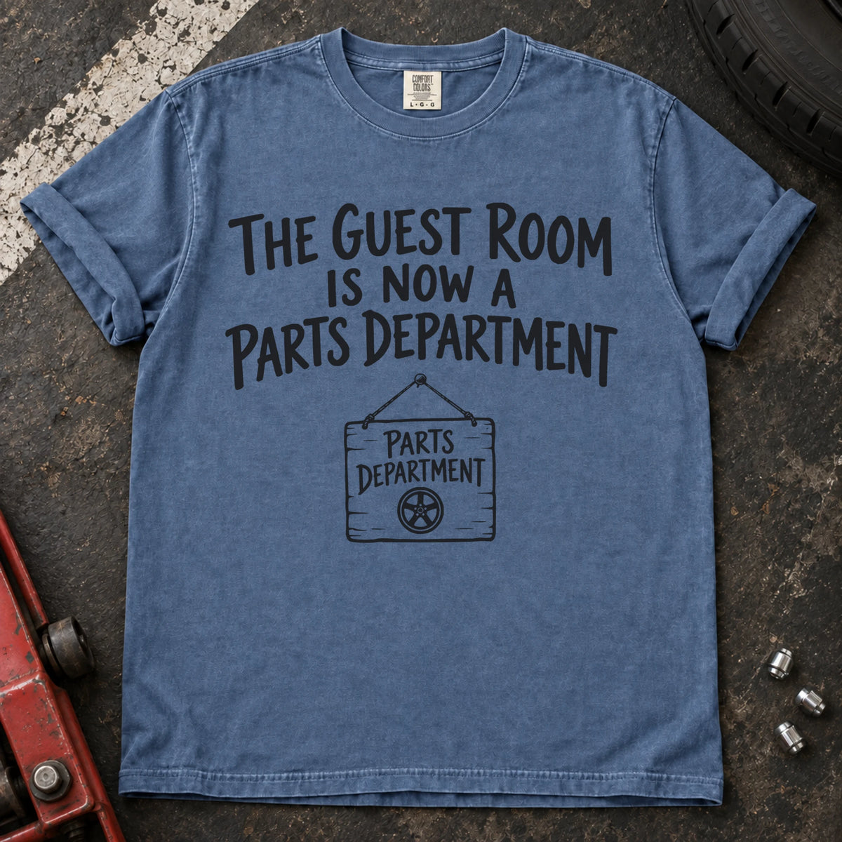 Blue Jean T-shirt showing a Parts Department sign beneath 'The guest room is now a parts department'.