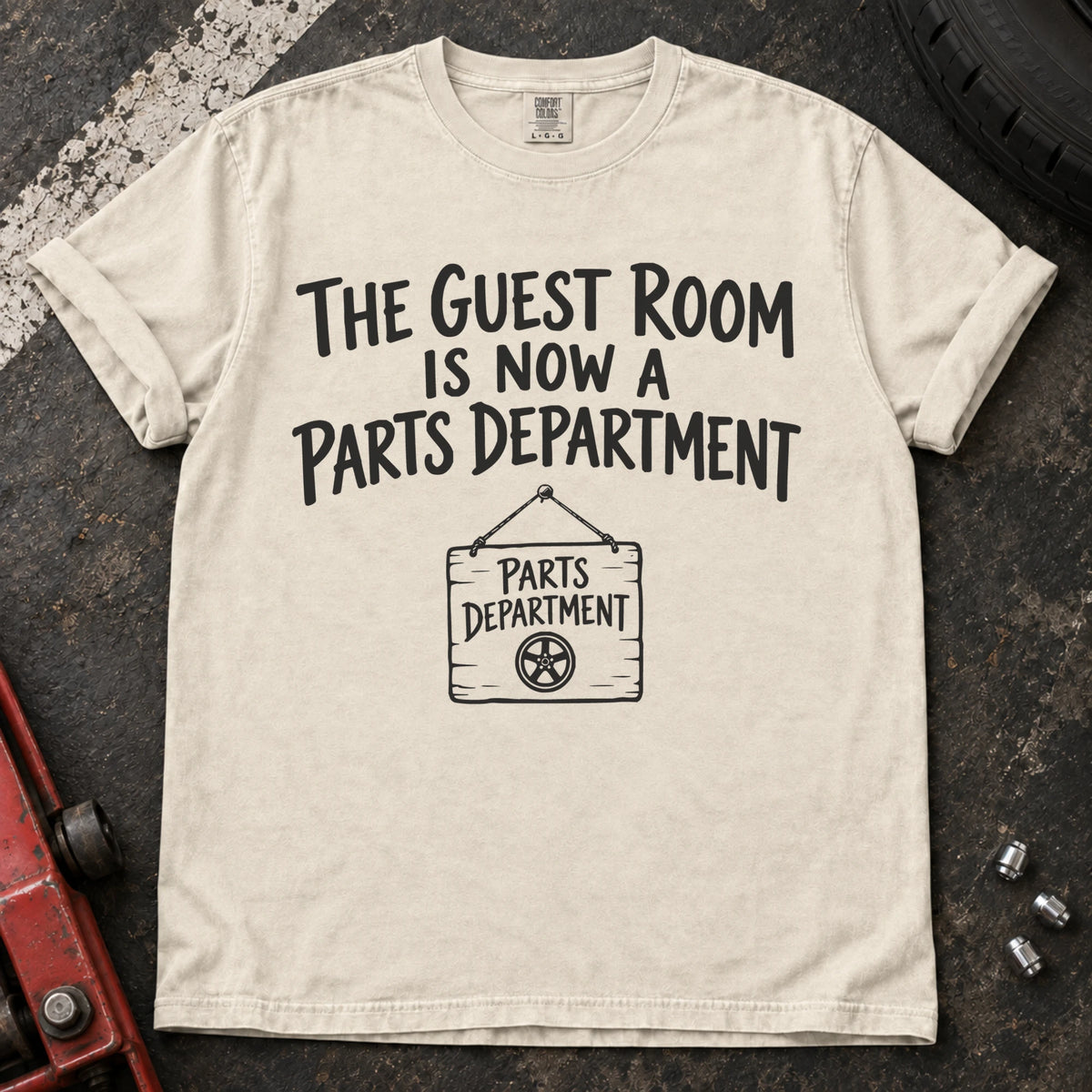Ivory T-shirt showing a Parts Department sign beneath 'The guest room is now a parts department'.