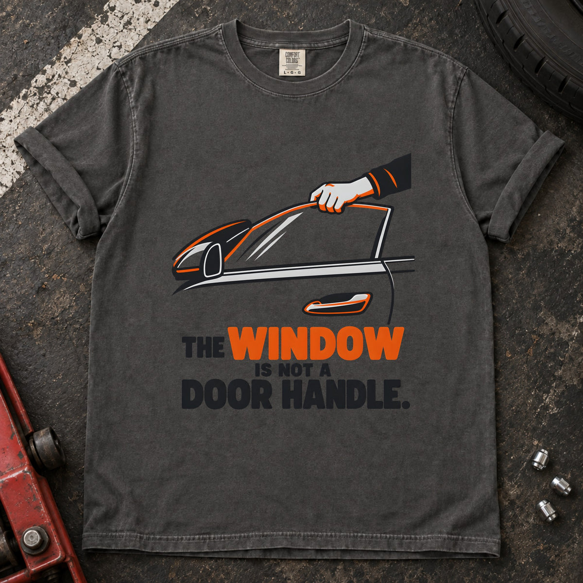 Pepper T-shirt showing a hand reaching through a car window with 'The window is not a door handle'.