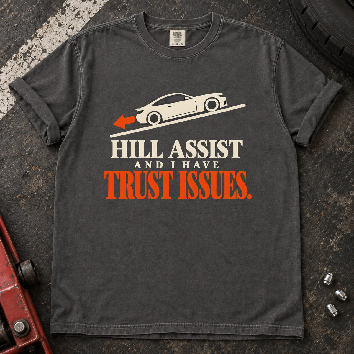 Pepper T-shirt showing a car on a slope with 'Hill assist and I have trust issues'.