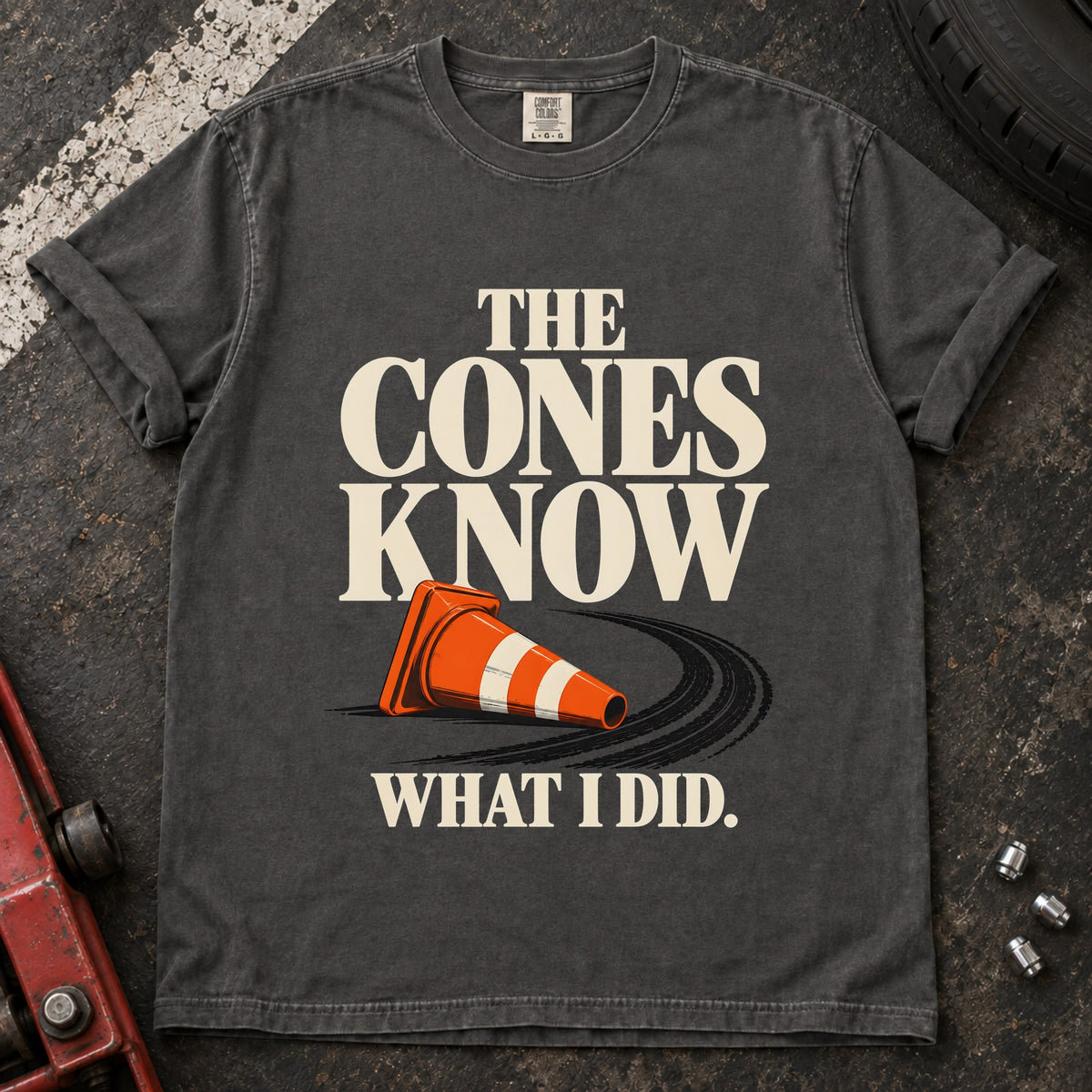 Pepper T-shirt showing a fallen orange traffic cone with 'The cones know what I did'.