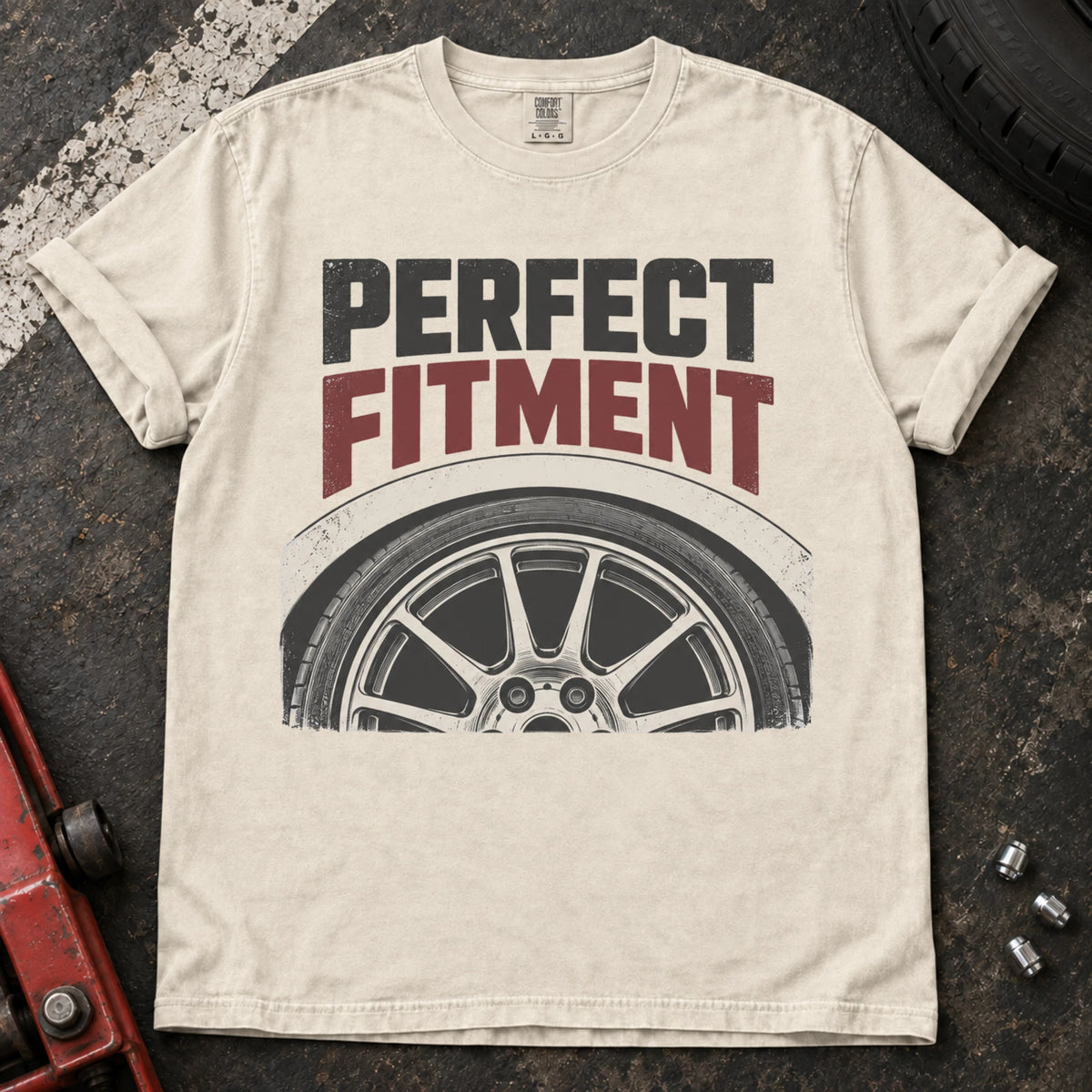 Ivory car enthusiast T-shirt. A close-up wheel celebrates the pursuit of perfect fitment.