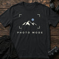 Black gaming T-shirt. A framed mountain-and-moon landscape celebrates pausing for photo mode.