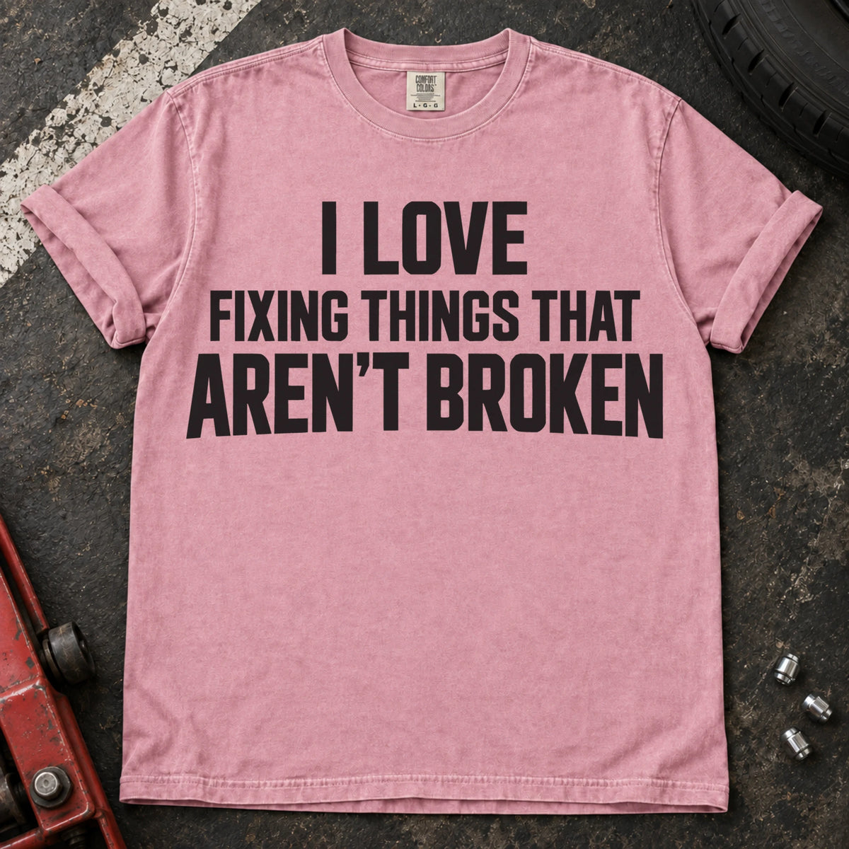 Blossom T-shirt with stacked lettering reading 'I love fixing things that aren't broken'.