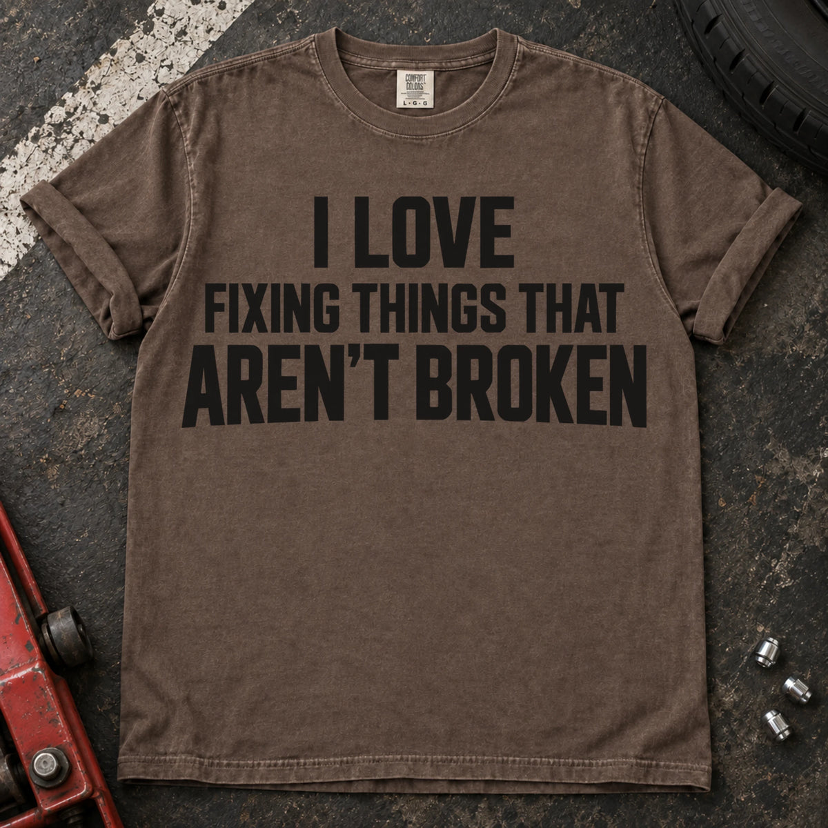 Espresso T-shirt with stacked lettering reading 'I love fixing things that aren't broken'.