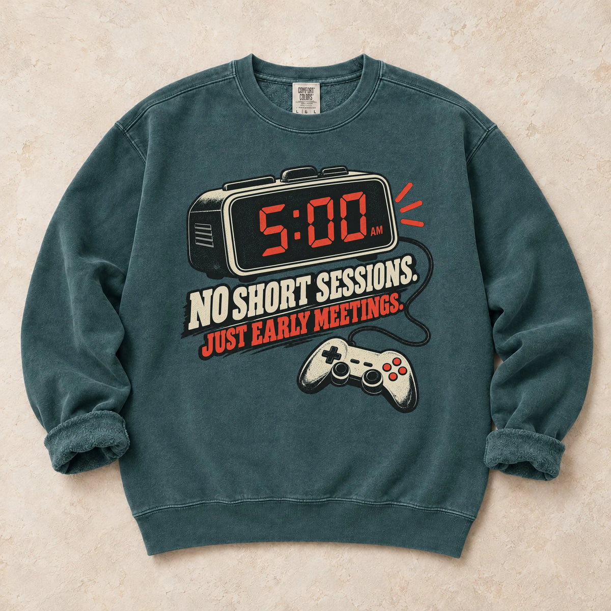Blue Spruce gaming sweatshirt. An early alarm and controller show there are no short sessions, just early meetings.