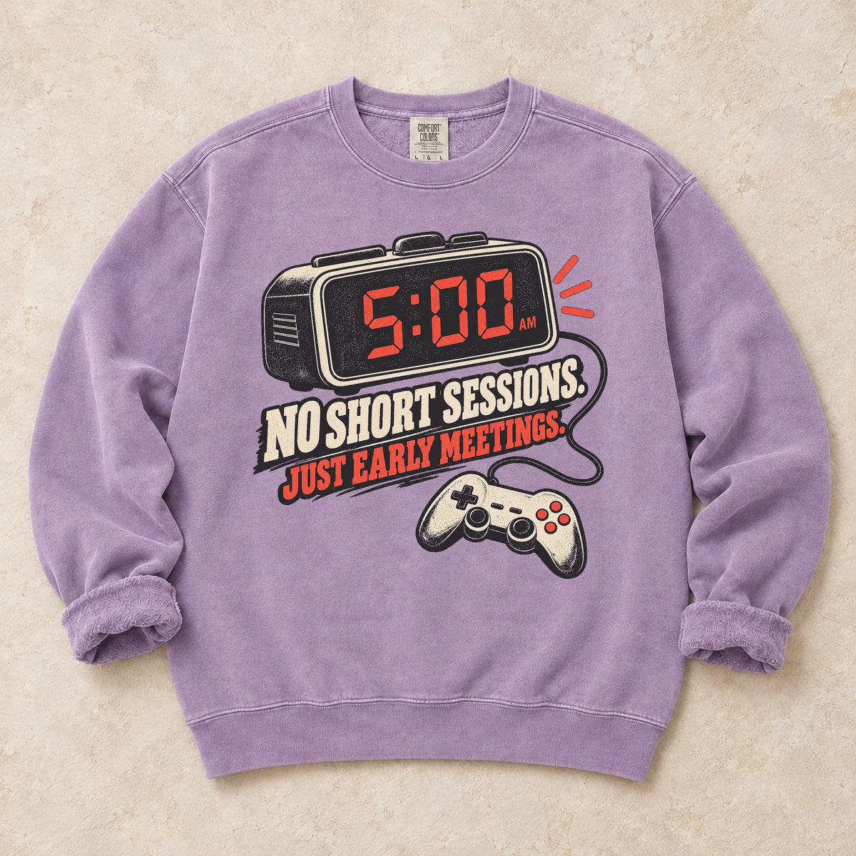 Orchid gaming sweatshirt. An early alarm and controller show there are no short sessions, just early meetings.