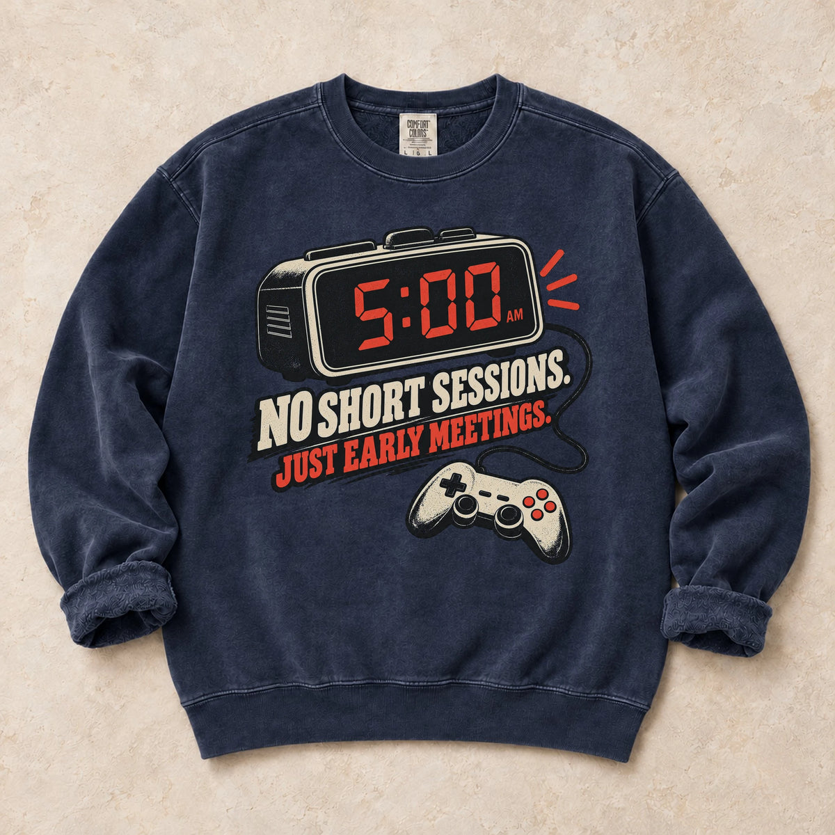 True Navy gaming sweatshirt. An early alarm and controller show there are no short sessions, just early meetings.