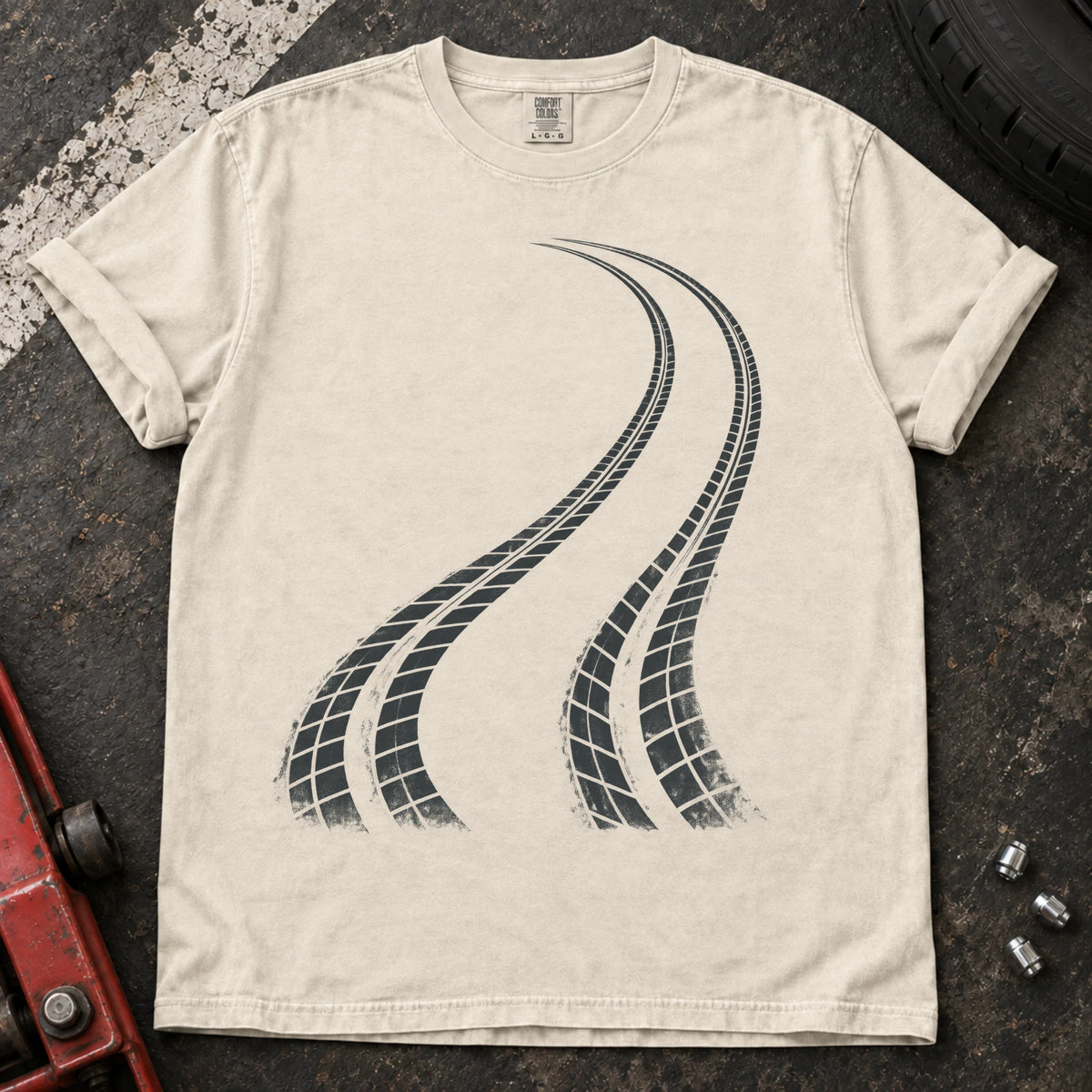 Ivory car enthusiast T-shirt. Two curving tire tracks capture a minimalist rear-bias driving graphic.