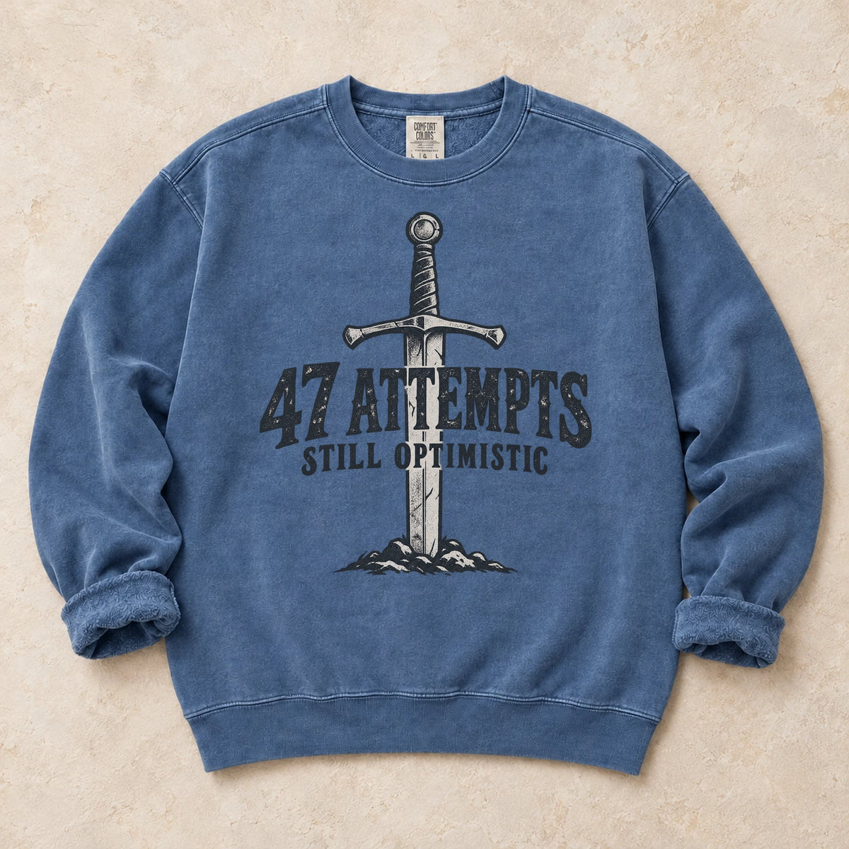 Blue Jean gaming sweatshirt. A planted sword celebrates 47 attempts and still optimistic.