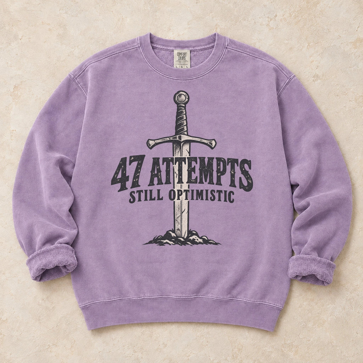 Orchid gaming sweatshirt. A planted sword celebrates 47 attempts and still optimistic.