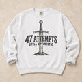 White gaming sweatshirt. A planted sword celebrates 47 attempts and still optimistic.