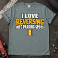 Bay T-shirt reading 'I love reversing into parking spots' above a small overhead car in a parking bay.
