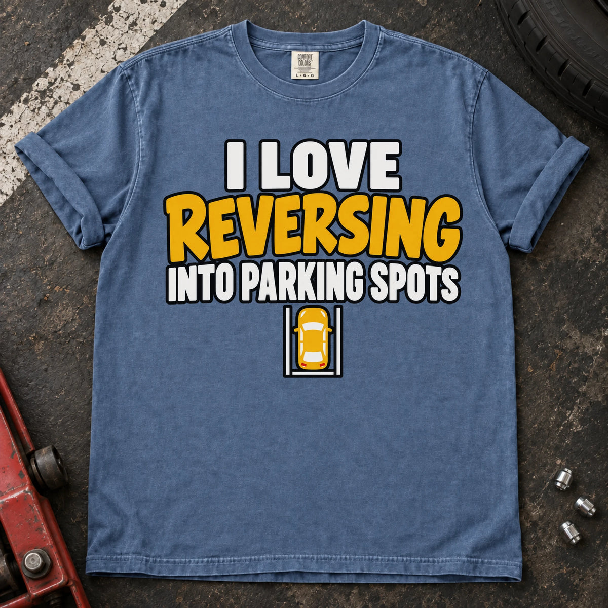 Blue Jean T-shirt reading 'I love reversing into parking spots' above a small overhead car in a parking bay.