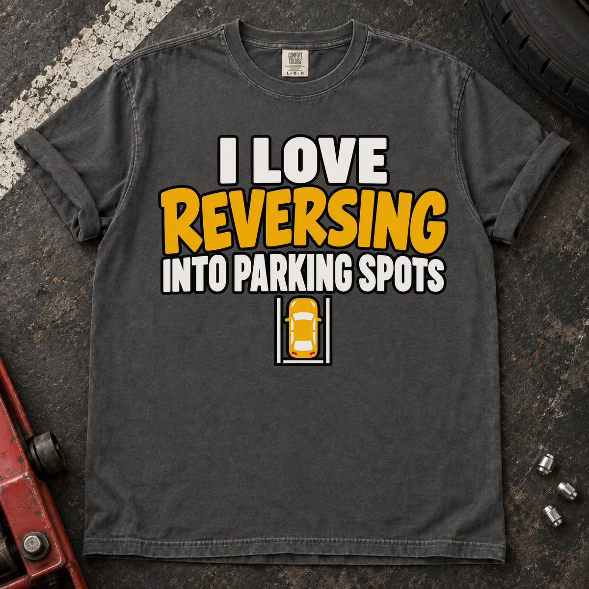 Pepper T-shirt reading 'I love reversing into parking spots' above a small overhead car in a parking bay.