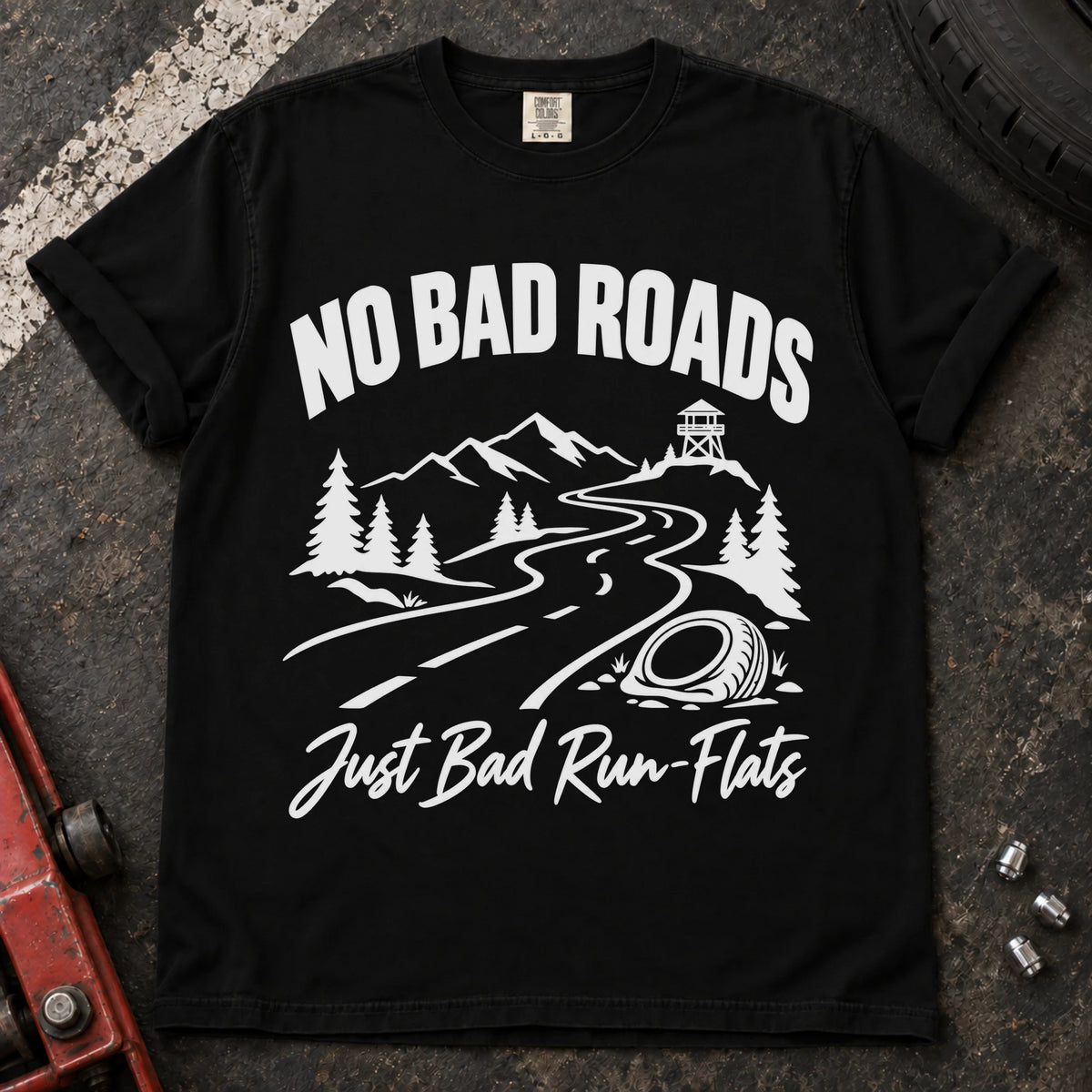 Black car enthusiast T-shirt. A mountain road and failed tire explain no bad roads, just bad run-flats.