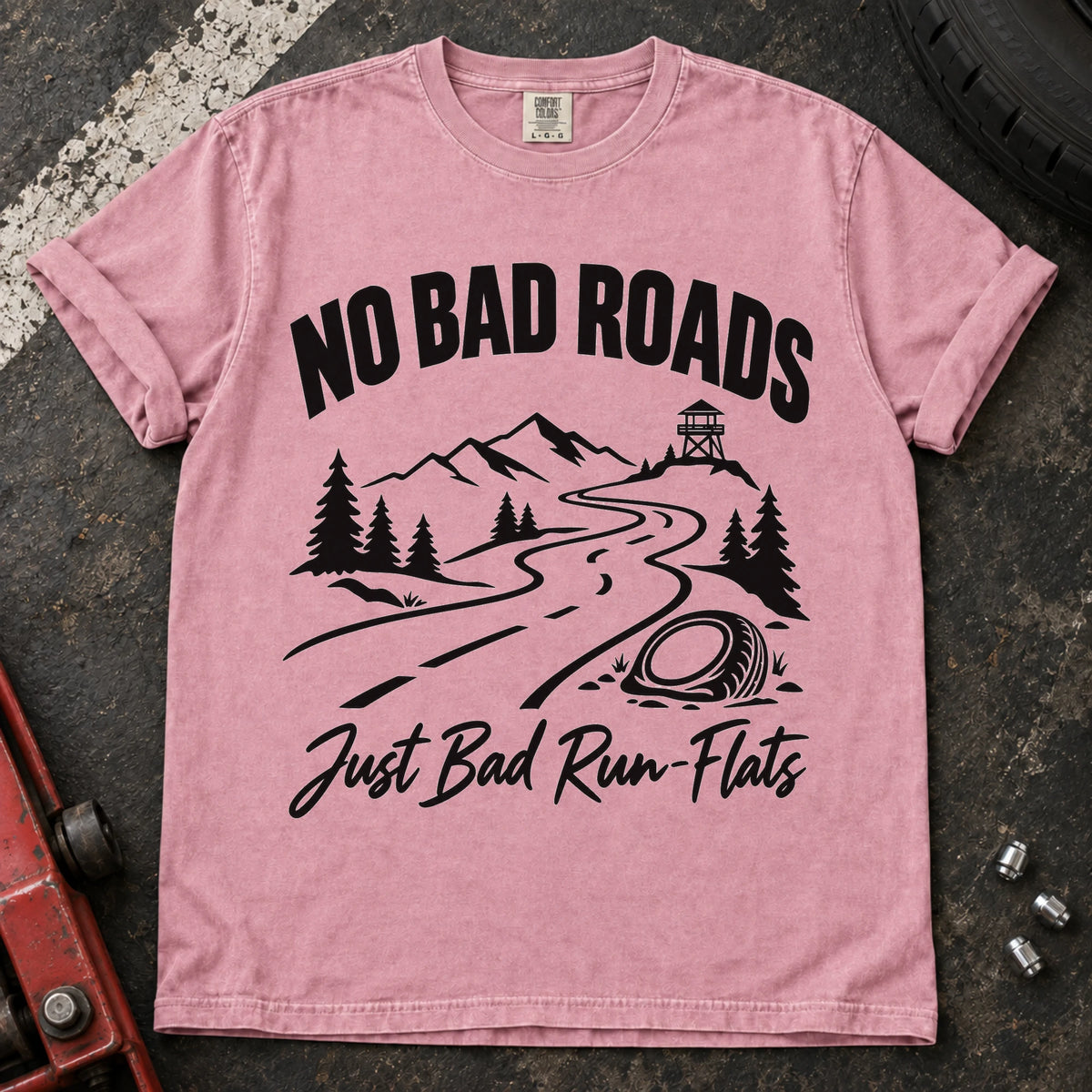 Blossom car enthusiast T-shirt. A mountain road and failed tire explain no bad roads, just bad run-flats.