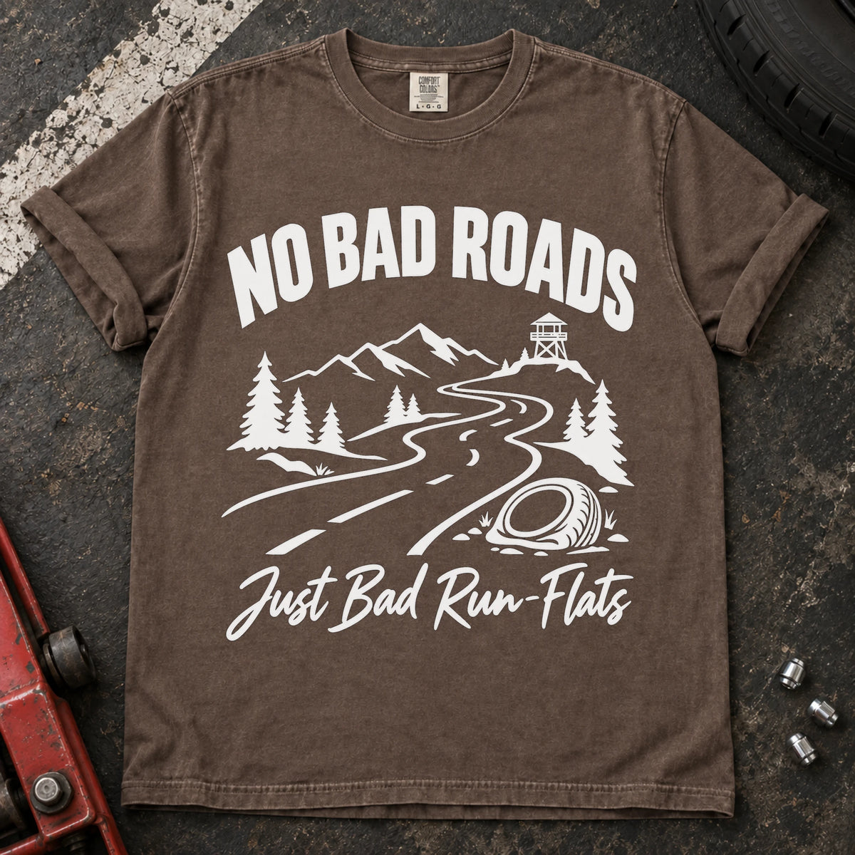 Espresso car enthusiast T-shirt. A mountain road and failed tire explain no bad roads, just bad run-flats.