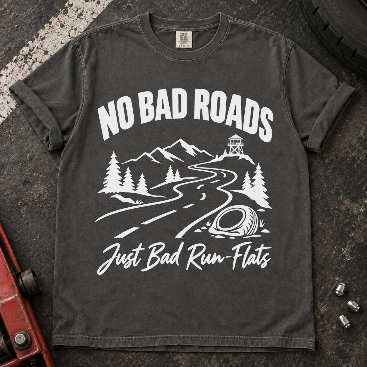 Pepper car enthusiast T-shirt. A mountain road and failed tire explain no bad roads, just bad run-flats.