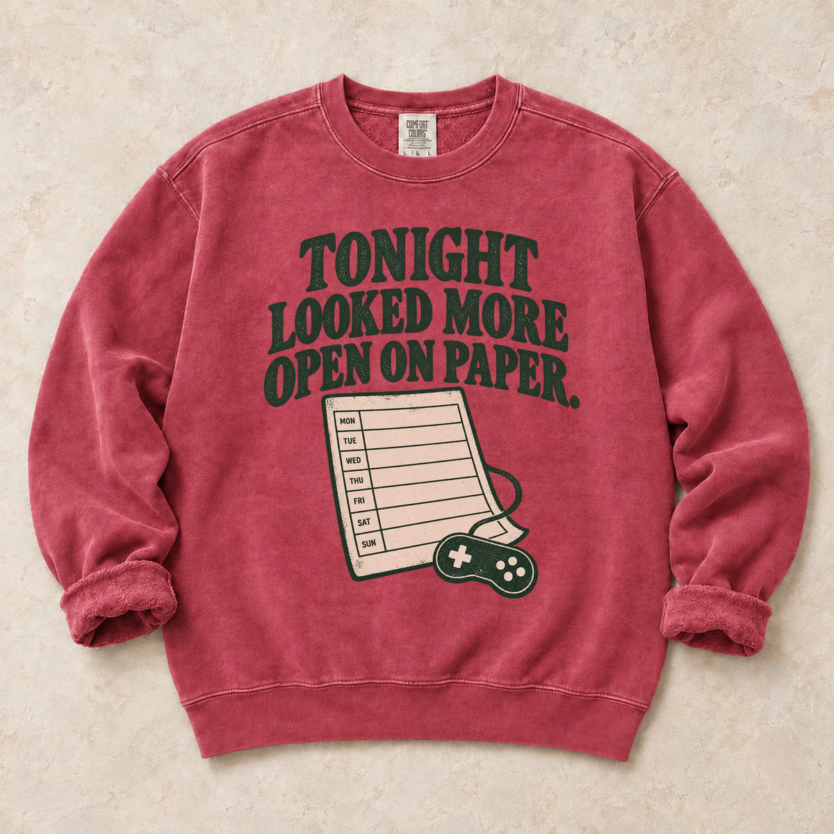 Crimson gaming sweatshirt. A calendar and controller reveal tonight looked more open on paper.