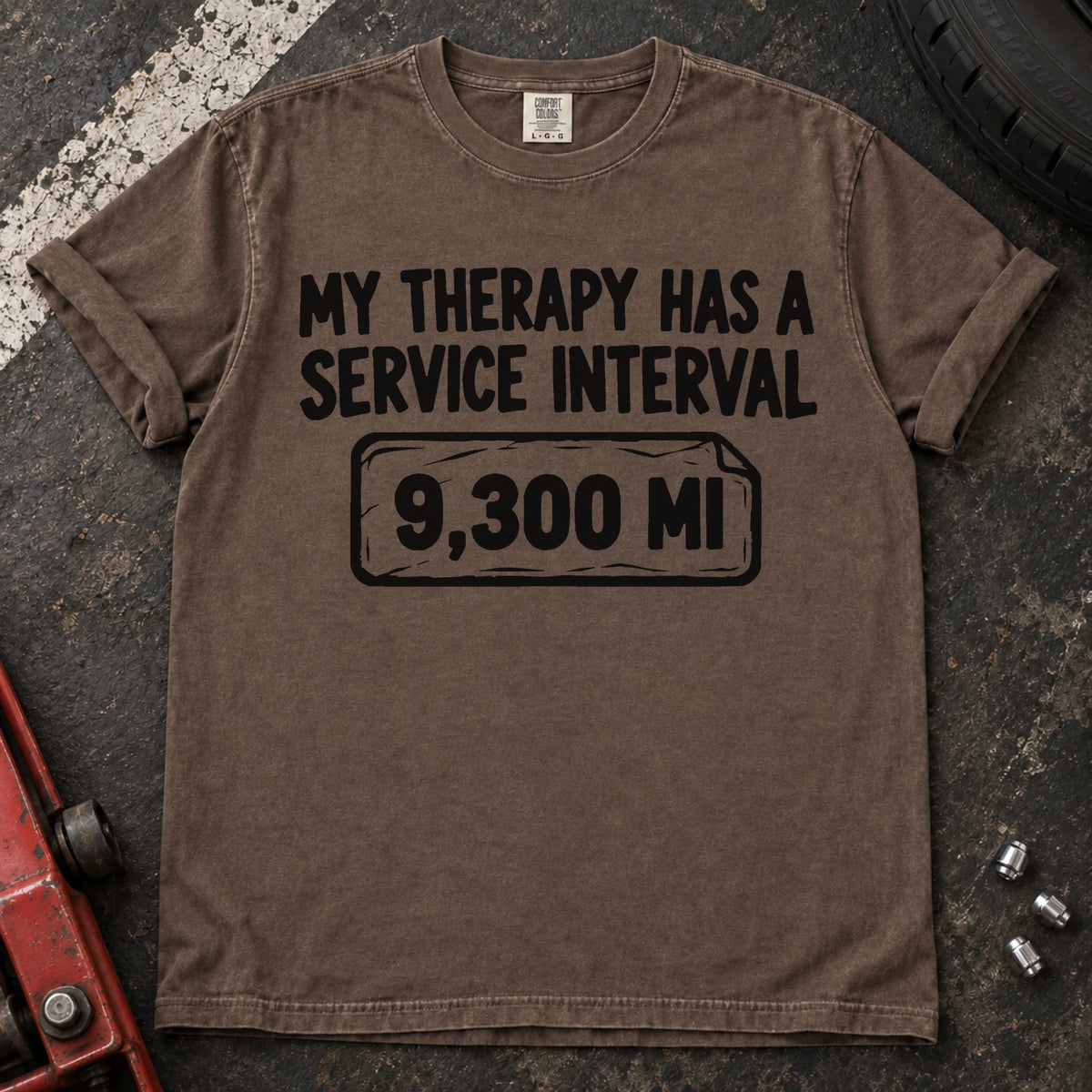 Espresso T-shirt reading 'My therapy has a service interval' above a mileage service reminder.