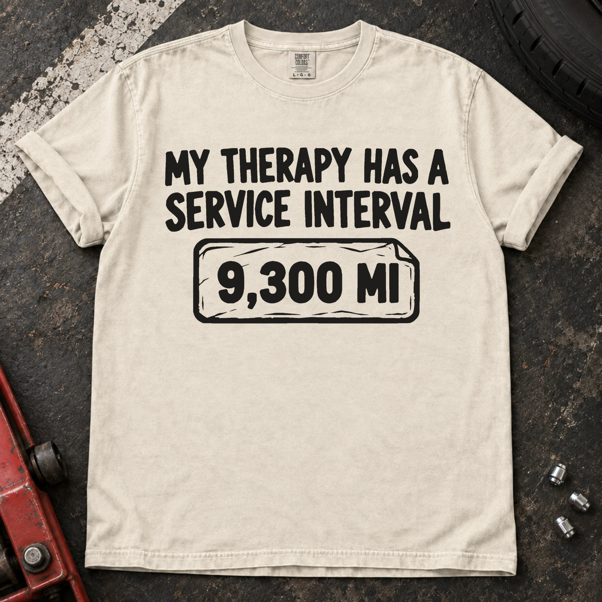 Ivory T-shirt reading 'My therapy has a service interval' above a mileage service reminder.
