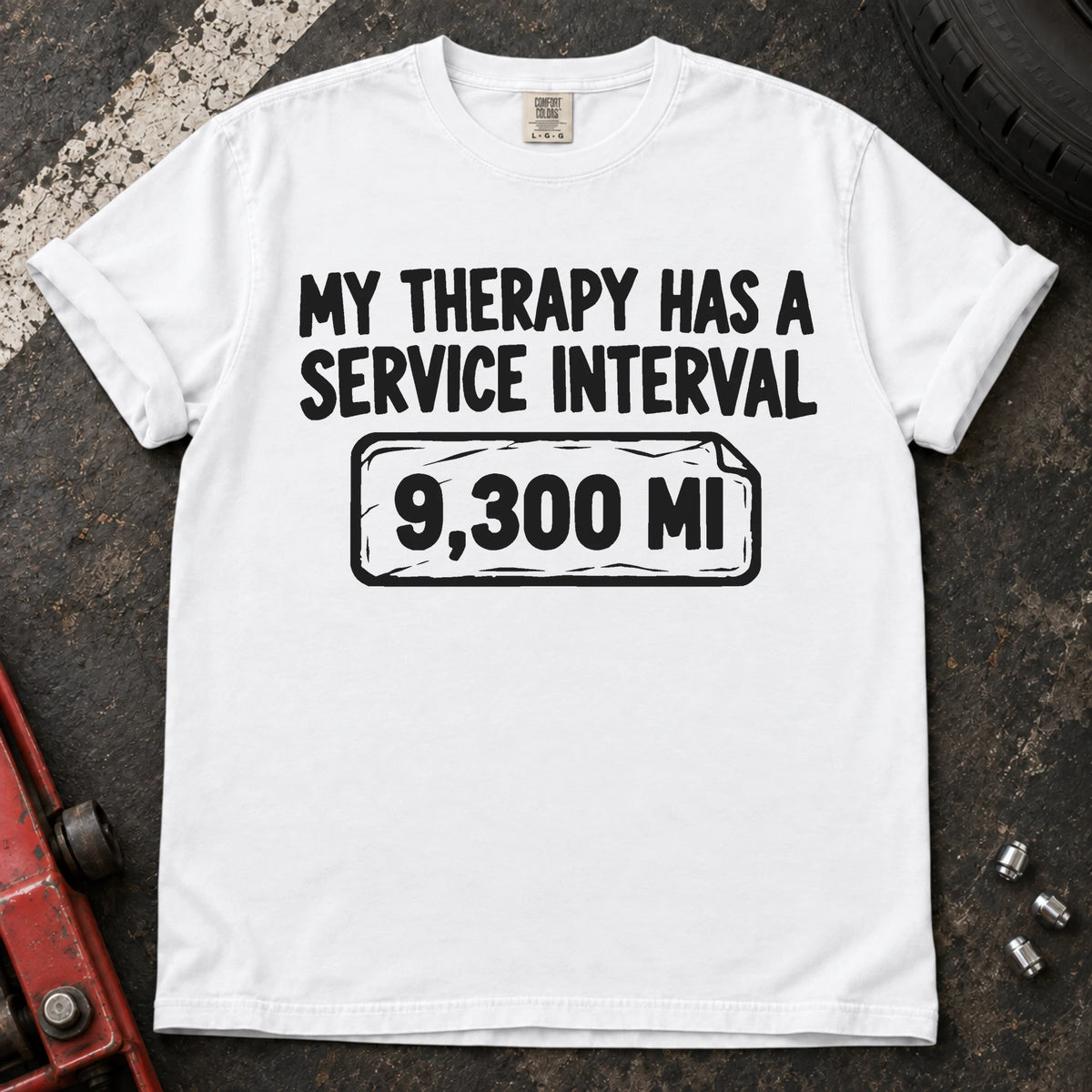 White T-shirt reading 'My therapy has a service interval' above a mileage service reminder.