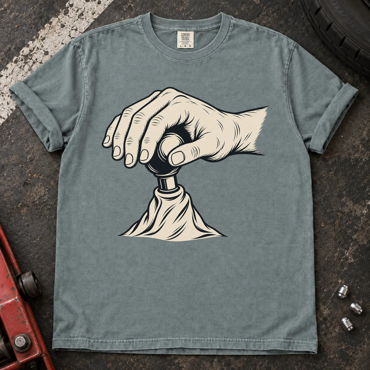 Bay car enthusiast T-shirt. A hand on a gear lever celebrates the small ritual of manual shifting.