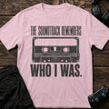 Light Pink gaming T-shirt. A cassette tape remembers who the player used to be.