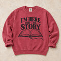 Crimson gaming sweatshirt. An open book declares I'm here for the story.