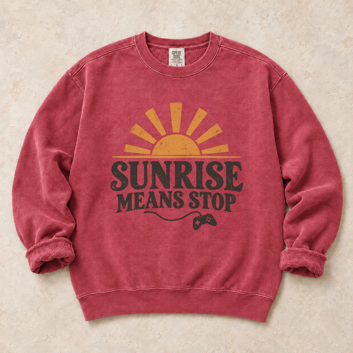Crimson gaming sweatshirt. A rising sun and controller remind night gamers that sunrise means stop.