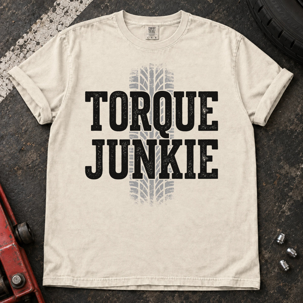 Ivory car enthusiast T-shirt. A tire-tread stripe backs bold Torque Junkie lettering.
