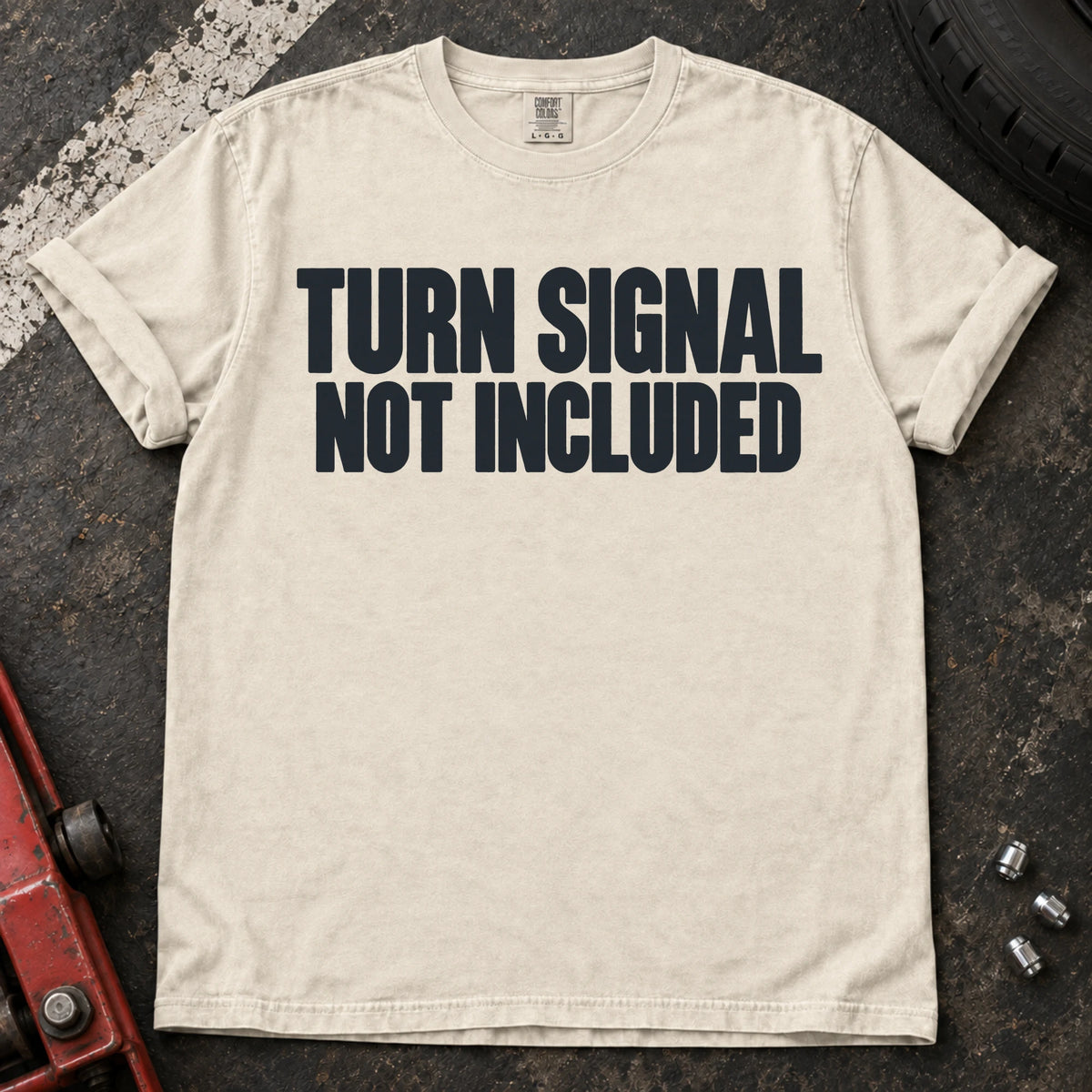 Ivory car enthusiast T-shirt. Turn signal not included: a deadpan automotive typography joke.