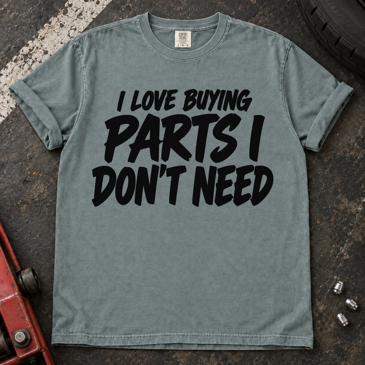 Bay T-shirt with bold black lettering reading 'I love buying parts I don't need'.