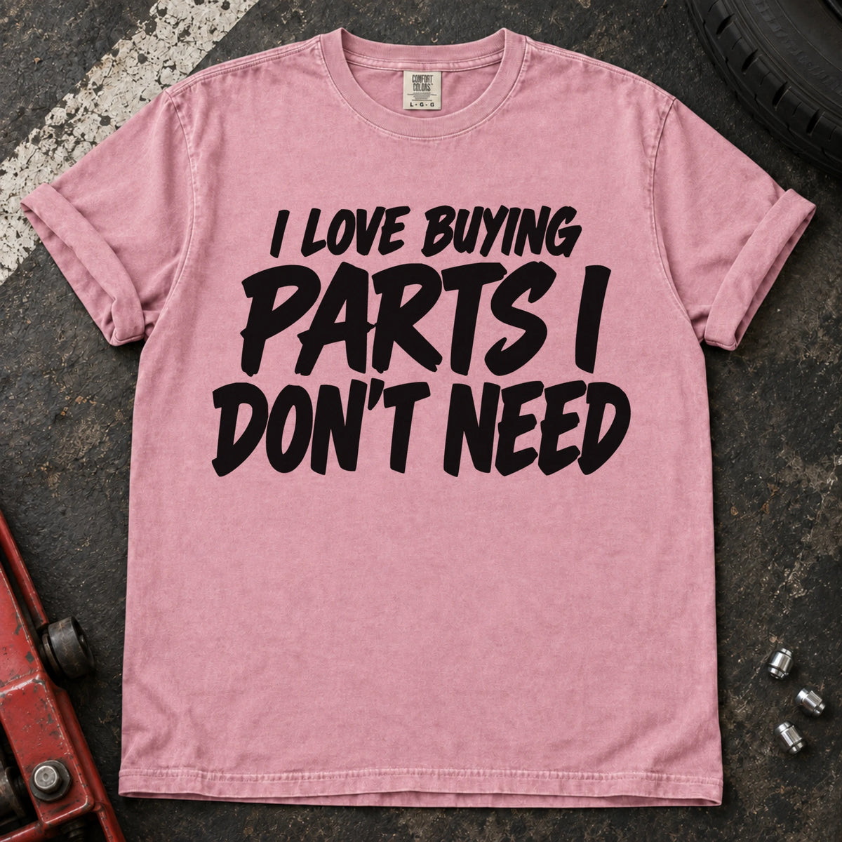 Blossom T-shirt with bold black lettering reading 'I love buying parts I don't need'.