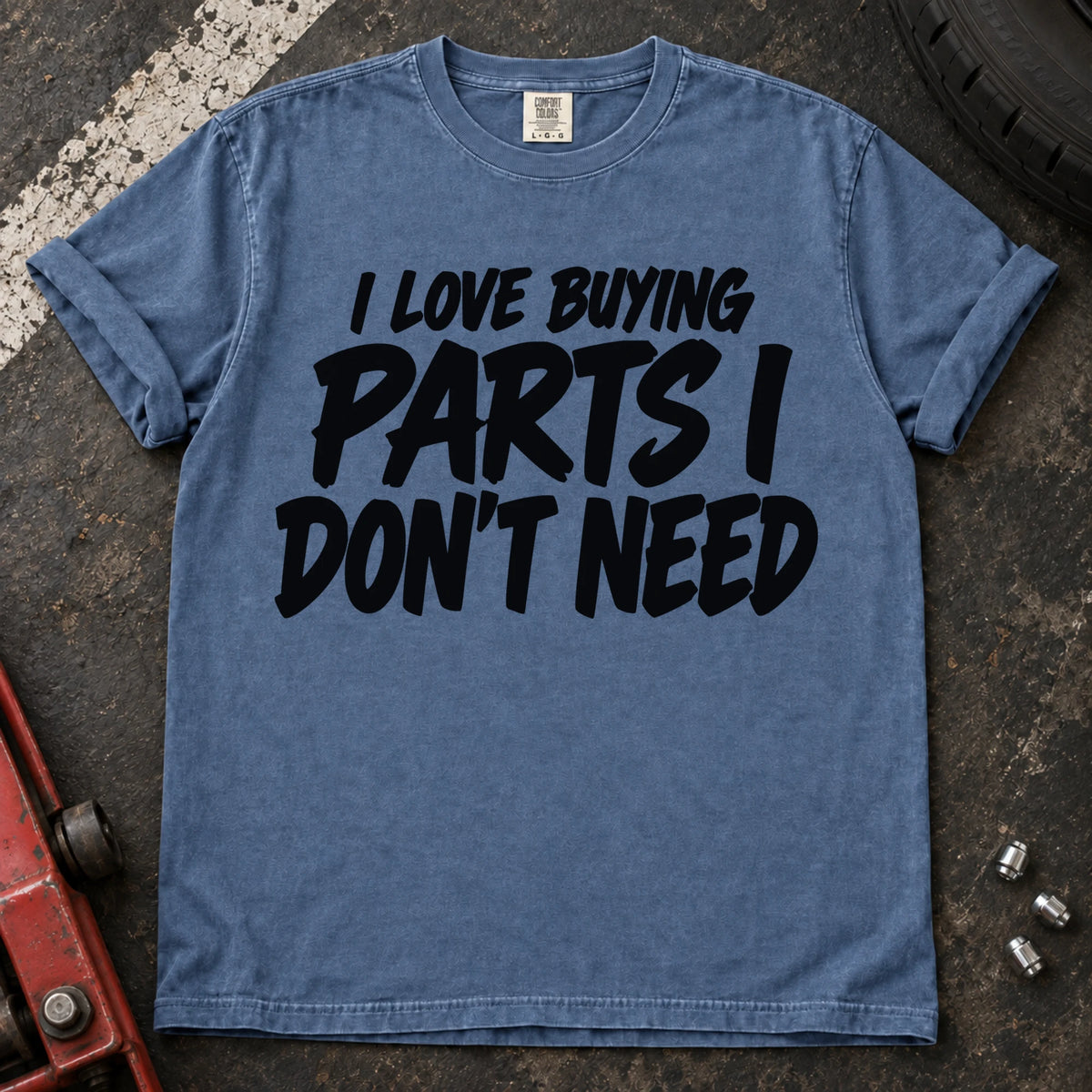 Blue Jean T-shirt with bold black lettering reading 'I love buying parts I don't need'.