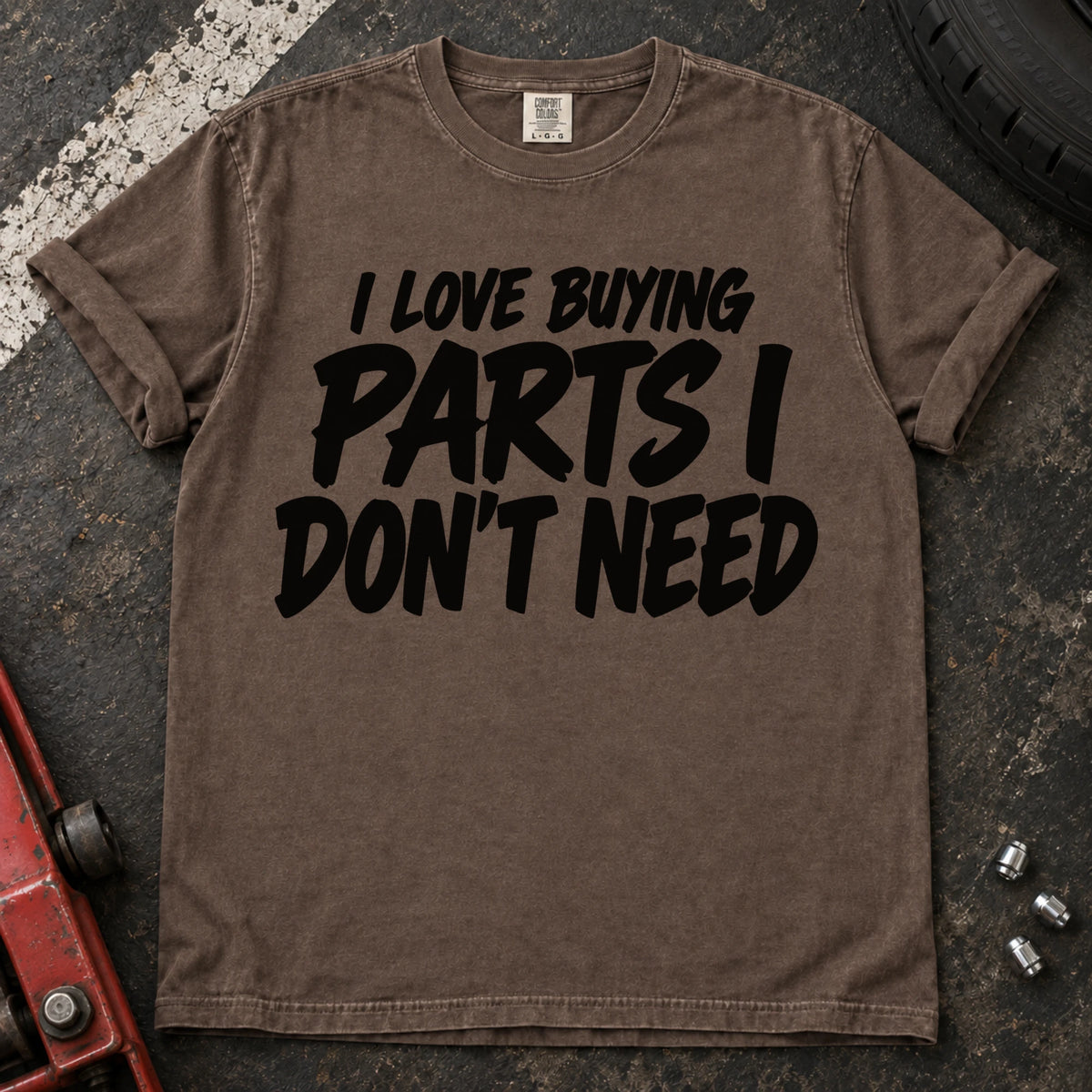 Espresso T-shirt with bold black lettering reading 'I love buying parts I don't need'.